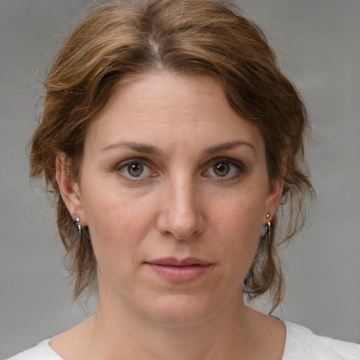 Joyful white adult female with medium  brown hair and brown eyes