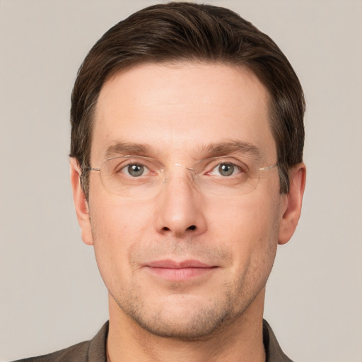 Joyful white adult male with short  brown hair and grey eyes