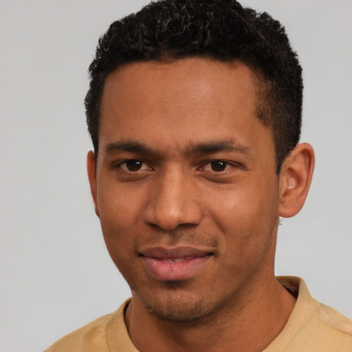 Joyful white young-adult male with short  black hair and brown eyes