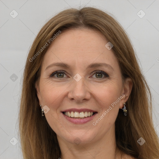 Joyful white adult female with long  brown hair and green eyes