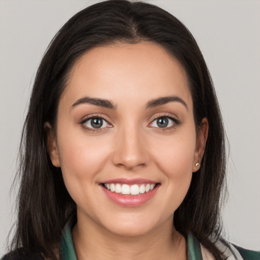 Joyful white young-adult female with long  brown hair and brown eyes