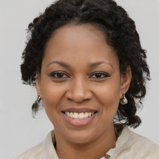 Joyful black young-adult female with medium  brown hair and brown eyes