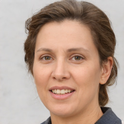 Joyful white adult female with medium  brown hair and grey eyes