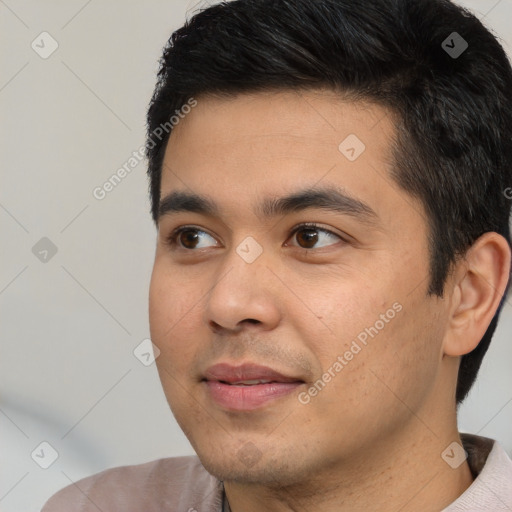 Joyful white young-adult male with short  black hair and brown eyes