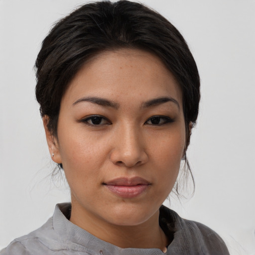 Joyful asian young-adult female with medium  brown hair and brown eyes