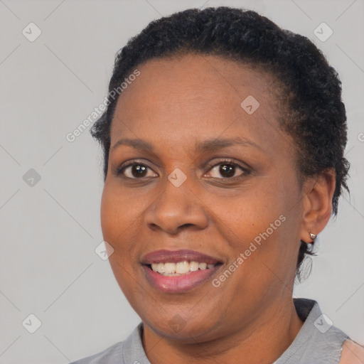 Joyful black adult female with short  brown hair and brown eyes