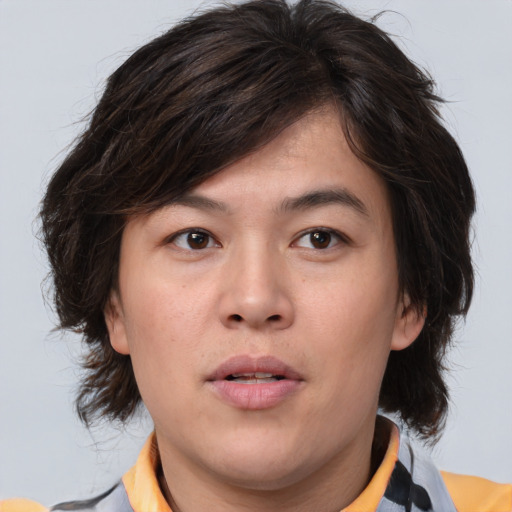 Joyful asian young-adult male with medium  brown hair and brown eyes