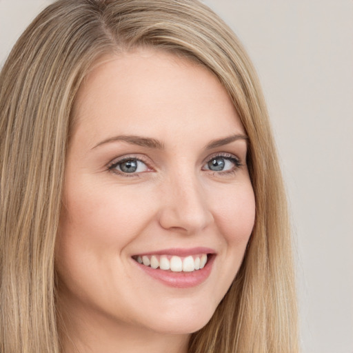 Joyful white young-adult female with long  brown hair and green eyes