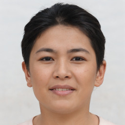 Joyful asian young-adult female with short  brown hair and brown eyes