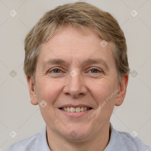 Joyful white adult male with short  brown hair and grey eyes