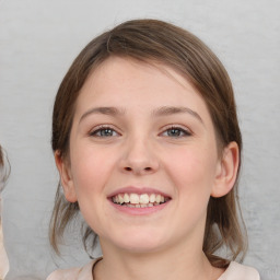 Joyful white young-adult female with medium  brown hair and blue eyes