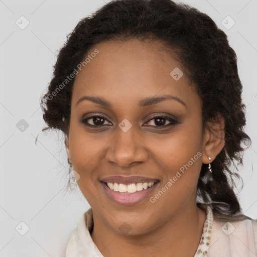 Joyful black young-adult female with long  brown hair and brown eyes