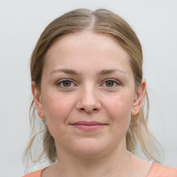 Joyful white young-adult female with medium  brown hair and grey eyes