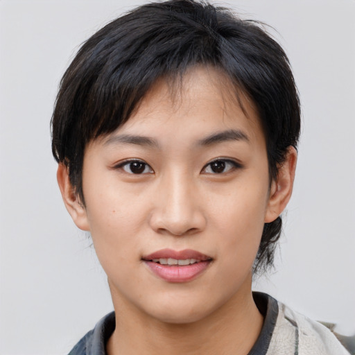 Joyful asian young-adult female with short  black hair and brown eyes