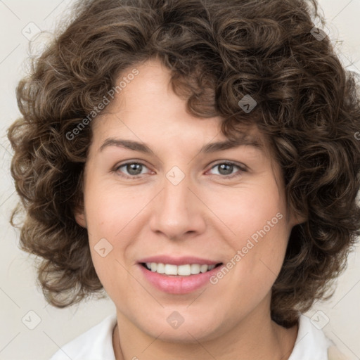 Joyful white young-adult female with medium  brown hair and green eyes