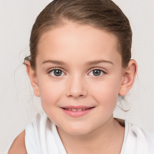 Joyful white child female with medium  brown hair and brown eyes