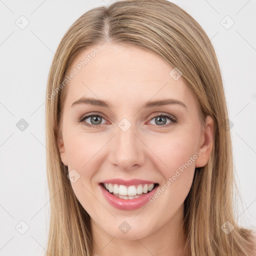 Joyful white young-adult female with long  brown hair and green eyes