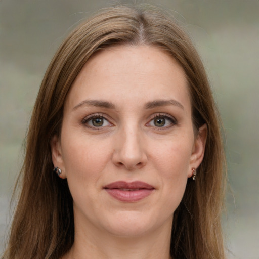 Joyful white young-adult female with long  brown hair and green eyes