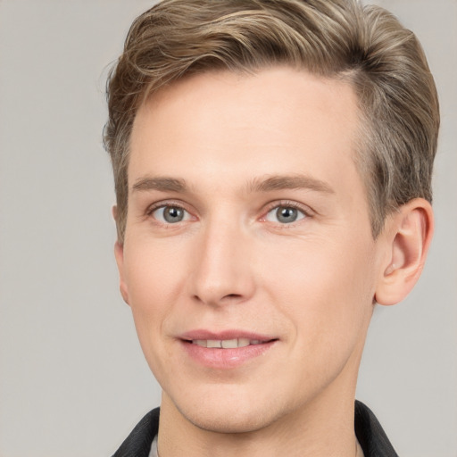 Joyful white young-adult male with short  brown hair and grey eyes