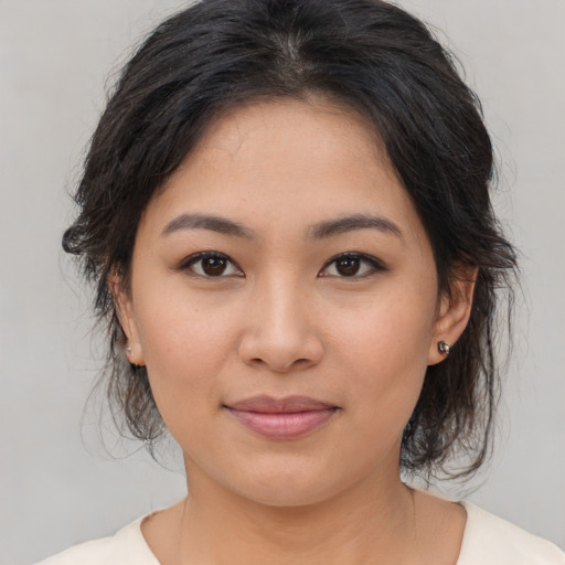 Joyful asian young-adult female with medium  brown hair and brown eyes