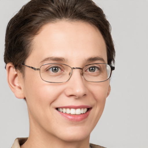 Joyful white adult female with short  brown hair and grey eyes