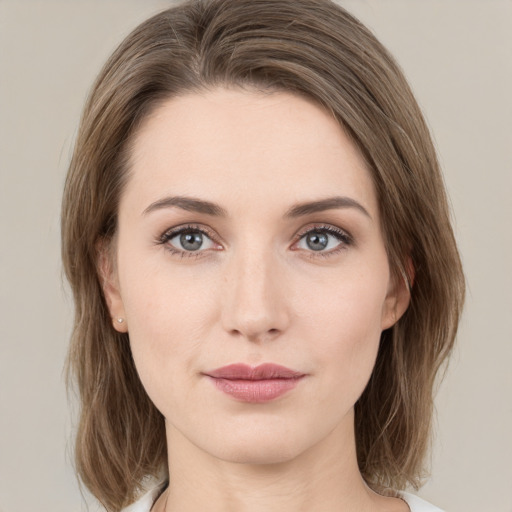 Joyful white young-adult female with medium  brown hair and green eyes