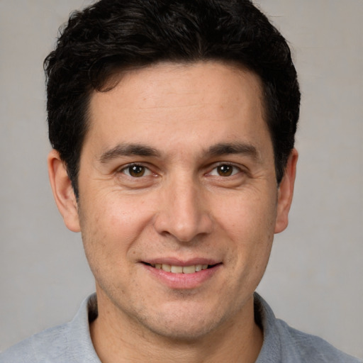 Joyful white adult male with short  brown hair and brown eyes