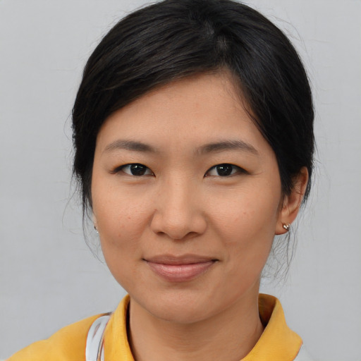 Joyful asian young-adult female with medium  brown hair and brown eyes