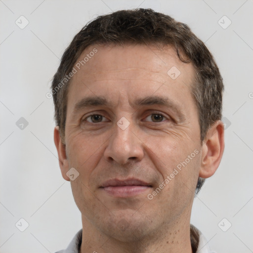 Joyful white adult male with short  brown hair and brown eyes