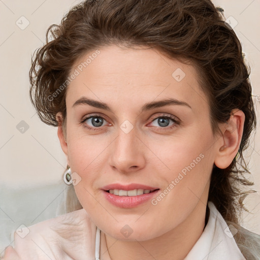 Joyful white young-adult female with medium  brown hair and blue eyes