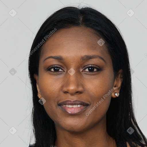 Joyful black young-adult female with long  black hair and brown eyes