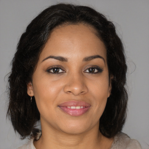 Joyful latino young-adult female with medium  brown hair and brown eyes
