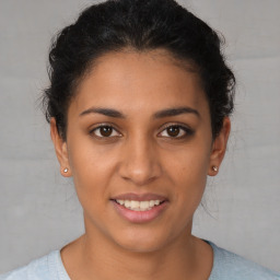 Joyful latino young-adult female with short  brown hair and brown eyes