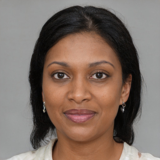 Joyful black young-adult female with medium  brown hair and brown eyes
