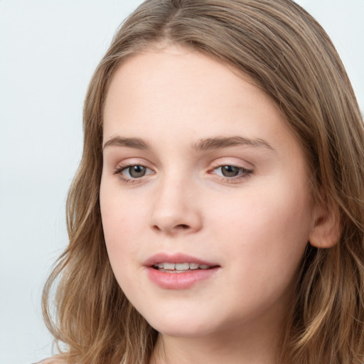 Joyful white young-adult female with long  brown hair and blue eyes