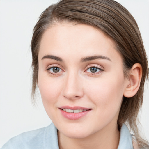 Joyful white young-adult female with medium  brown hair and blue eyes