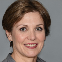 Joyful white adult female with medium  brown hair and grey eyes