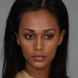 Neutral black young-adult female with long  brown hair and brown eyes