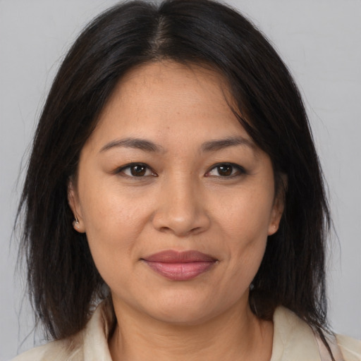 Joyful asian adult female with medium  brown hair and brown eyes