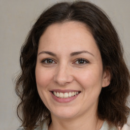 Joyful white adult female with medium  brown hair and brown eyes