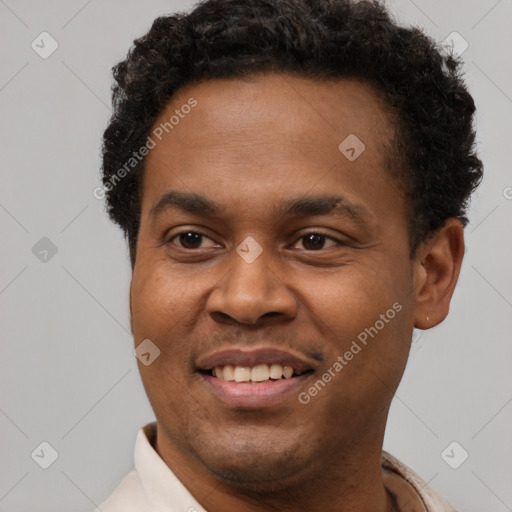 Joyful black young-adult male with short  brown hair and brown eyes