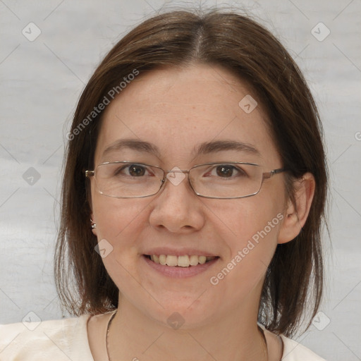 Joyful white adult female with medium  brown hair and brown eyes