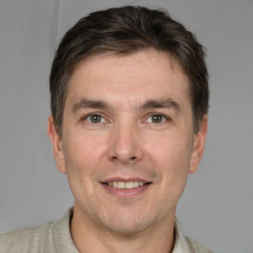 Joyful white adult male with short  brown hair and grey eyes