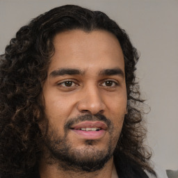 Joyful black young-adult male with short  brown hair and brown eyes