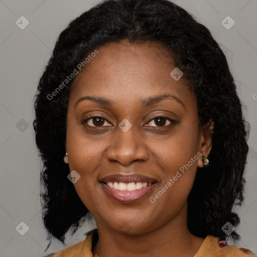 Joyful black adult female with long  brown hair and brown eyes