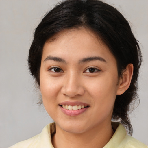 Joyful white young-adult female with medium  brown hair and brown eyes