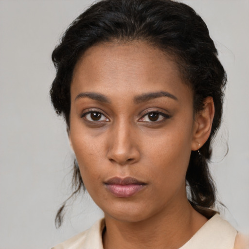 Neutral black young-adult female with medium  brown hair and brown eyes