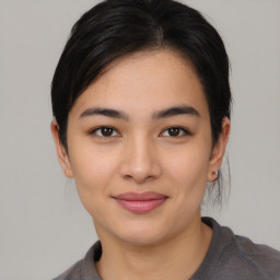 Joyful asian young-adult female with medium  black hair and brown eyes