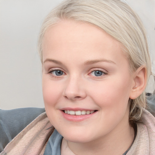 Joyful white young-adult female with medium  brown hair and blue eyes