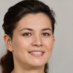 Joyful white young-adult female with long  brown hair and brown eyes